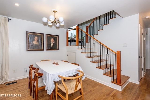 dining room featuring wood finished floors, a chandelier, stairway, baseboards, and recessed lighting