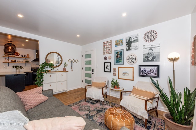 living room with wood finished floors, recessed lighting, and baseboards
