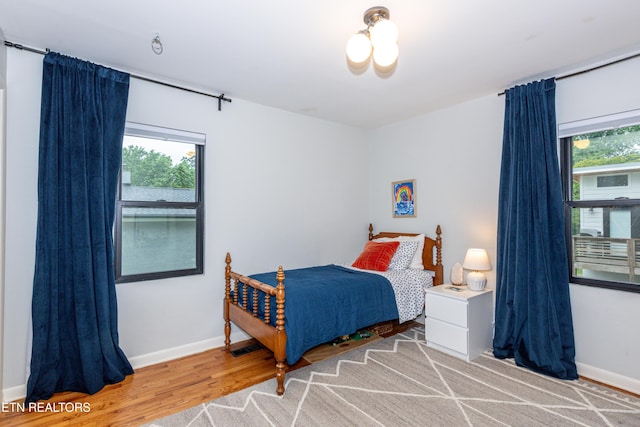 bedroom featuring light wood-style flooring and baseboards