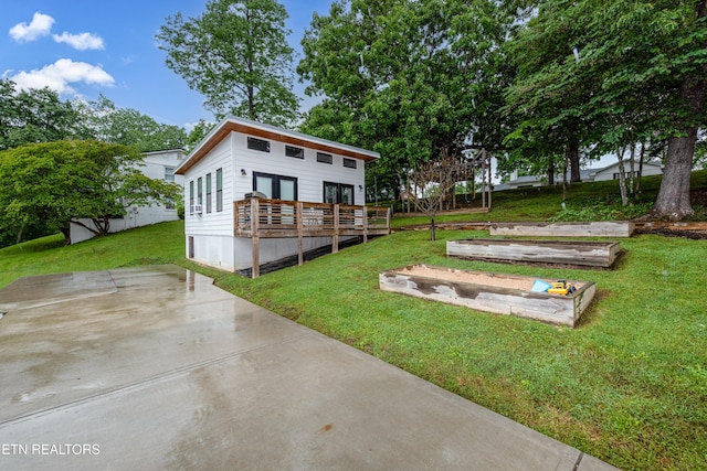 back of house with a yard and a wooden deck