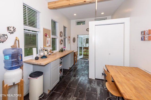 kitchen with wooden counters, recessed lighting, beamed ceiling, and gray cabinetry