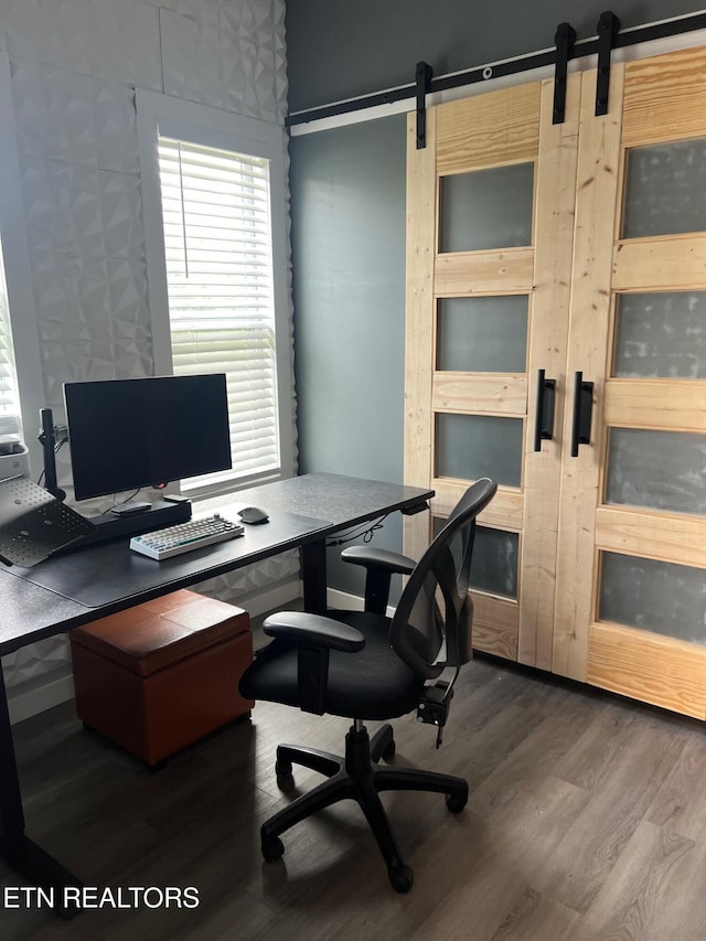 office featuring wood finished floors and a barn door