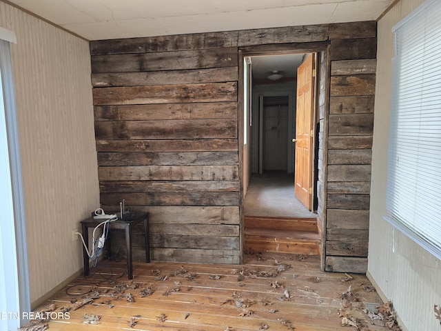 hall featuring wooden walls and hardwood / wood-style flooring