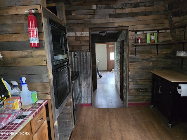 interior space featuring wood-type flooring and wood walls