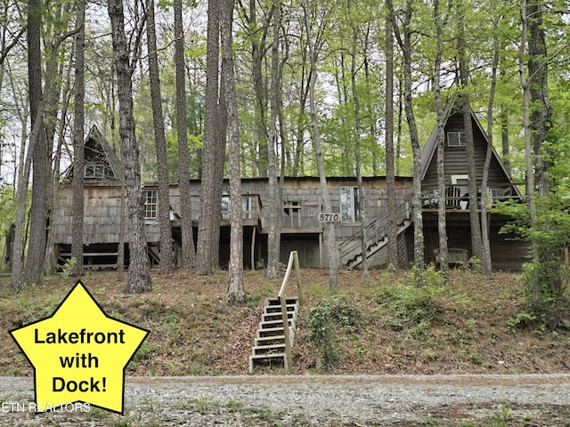 view of front of property featuring stairs and a deck
