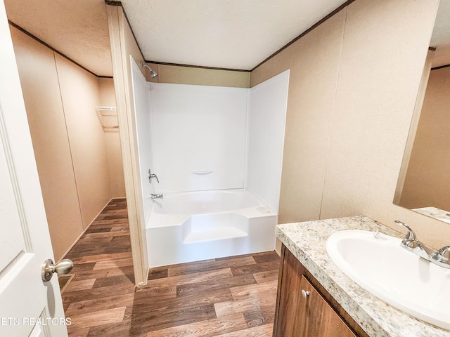 bathroom featuring a shower, wood finished floors, vanity, and a bath