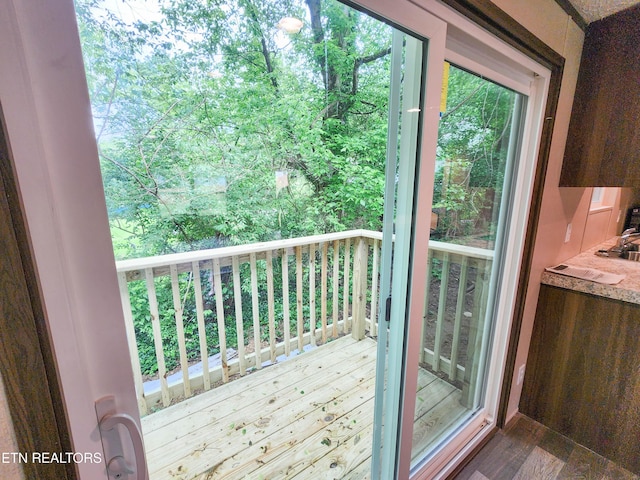 doorway to outside with dark wood-style floors