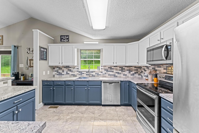 kitchen with a sink, white cabinets, blue cabinets, and stainless steel appliances
