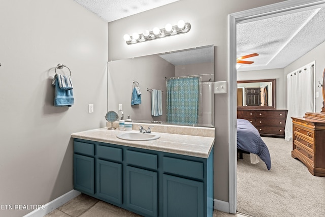bathroom with a shower with shower curtain, ceiling fan, a textured ceiling, and vanity