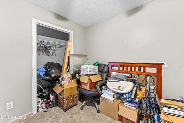 bedroom with a textured ceiling, a closet, and carpet flooring