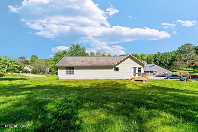 back of property featuring a lawn