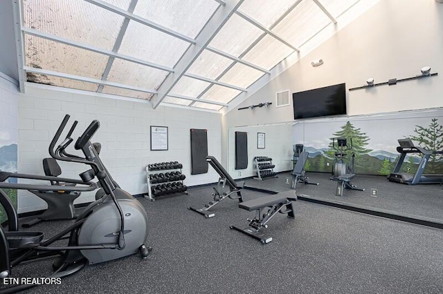 gym with visible vents and high vaulted ceiling