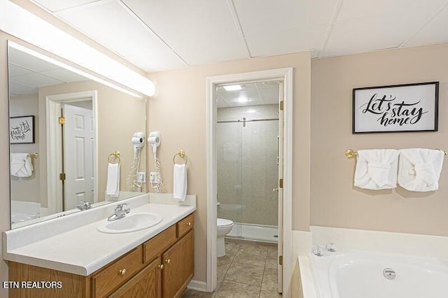 full bath featuring a stall shower, toilet, tile patterned floors, a garden tub, and vanity