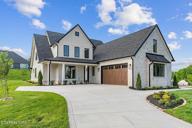 922 Eagle Point Dr, Loudon, TN 37774 - modern farmhouse featuring board and batten siding, brick siding, a garage, concrete driveway, and a front yard