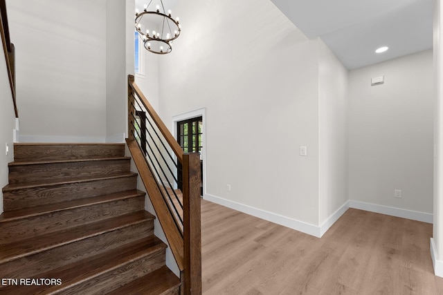 922 Eagle Point Dr, Loudon, TN 37774 - stairs with wood finished floors, baseboards, and a notable chandelier