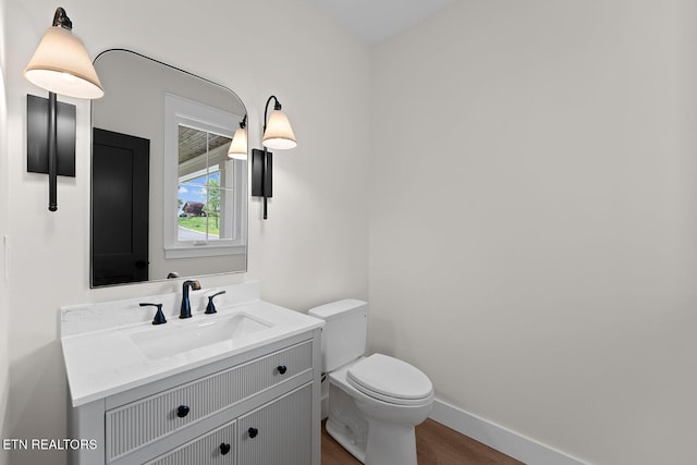 922 Eagle Point Dr, Loudon, TN 37774 - bathroom featuring toilet, baseboards, wood finished floors, and vanity