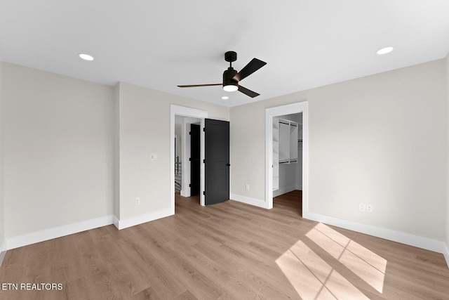 922 Eagle Point Dr, Loudon, TN 37774 - unfurnished bedroom with light wood finished floors, a closet, baseboards, a spacious closet, and recessed lighting