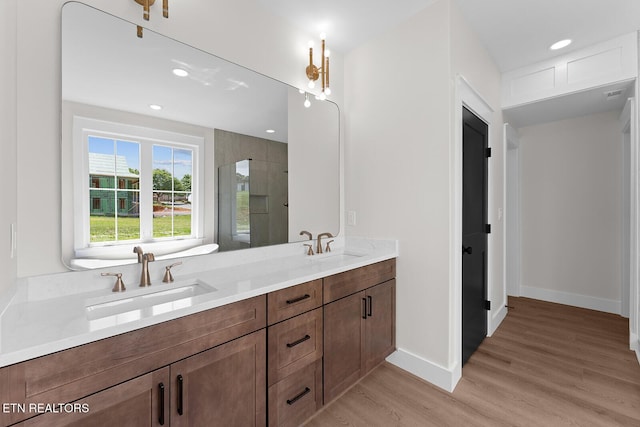 922 Eagle Point Dr, Loudon, TN 37774 - full bath featuring double vanity, wood finished floors, tiled shower, a sink, and baseboards