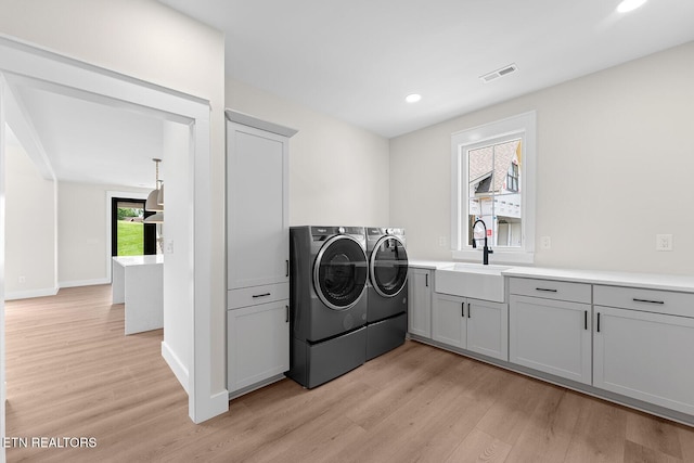 922 Eagle Point Dr, Loudon, TN 37774 - laundry area featuring a sink, cabinet space, washer and clothes dryer, light wood-style floors, and recessed lighting