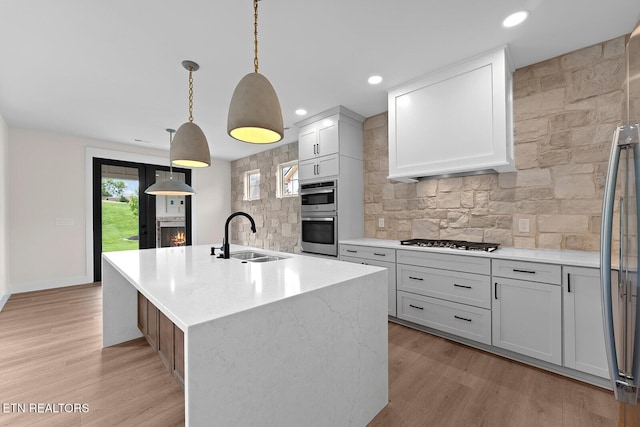 922 Eagle Point Dr, Loudon, TN 37774 - kitchen featuring a sink, stainless steel appliances, decorative backsplash, and light wood-type flooring