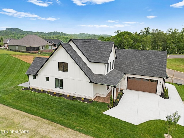 922 Eagle Point Dr, Loudon, TN 37774 - modern farmhouse featuring roof with shingles, an attached garage, concrete driveway, a front yard, and board and batten siding