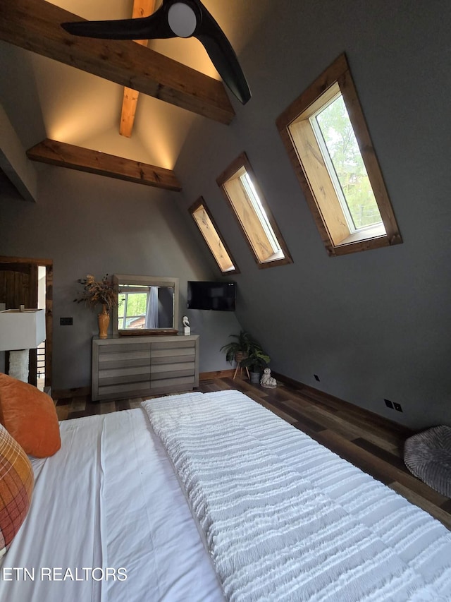 bedroom with lofted ceiling with skylight and wood finished floors