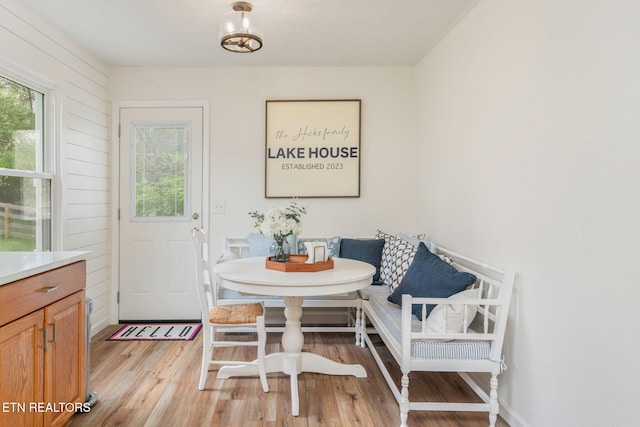 dining space featuring breakfast area and light wood-style flooring