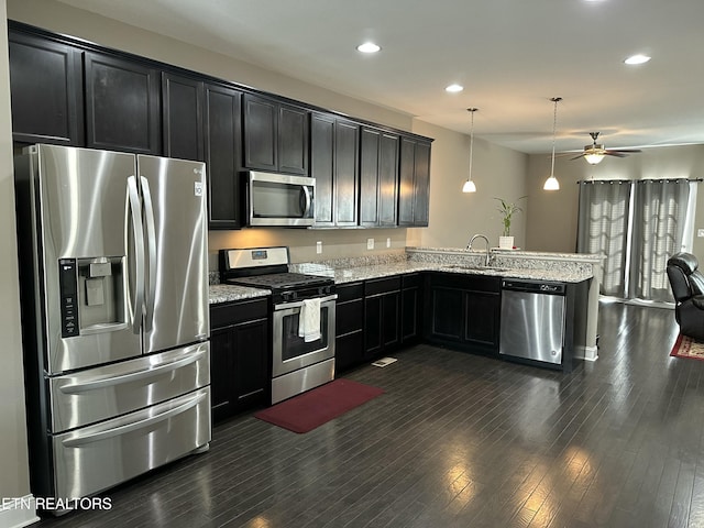 1631 Silver Spur Ln, Knoxville, TN 37932 - kitchen with a sink, stainless steel appliances, dark cabinetry, a peninsula, and open floor plan