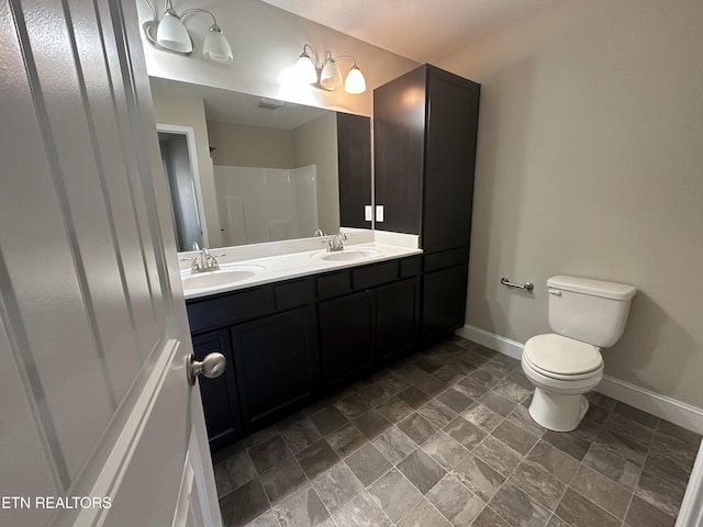 1631 Silver Spur Ln, Knoxville, TN 37932 - full bathroom with baseboards, toilet, double vanity, and a sink