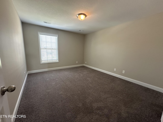 1631 Silver Spur Ln, Knoxville, TN 37932 - unfurnished room featuring dark colored carpet, a textured ceiling, and baseboards