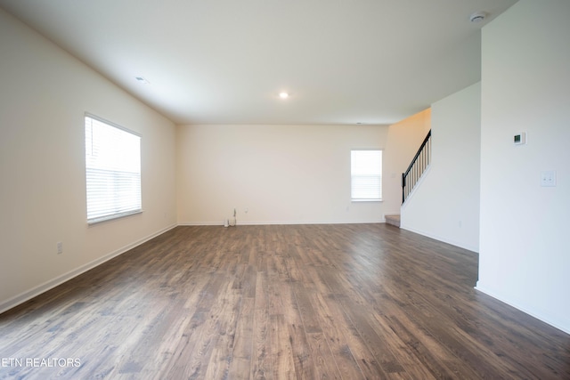 unfurnished living room featuring stairway, baseboards, recessed lighting, and dark wood finished floors