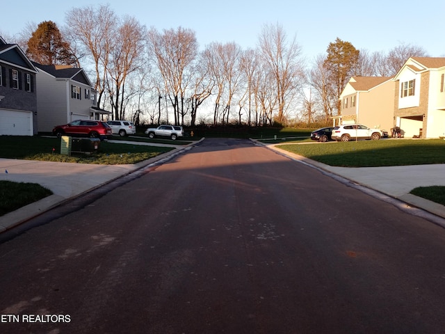 view of road featuring a residential view and curbs