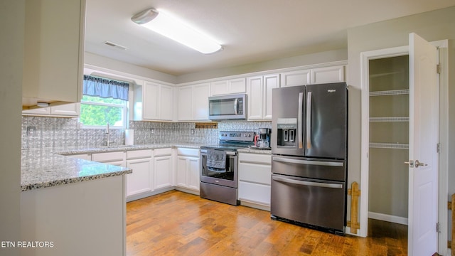 645 Bryce View Ln, Sevierville, TN 37876 - kitchen with visible vents, white cabinetry, and appliances with stainless steel finishes