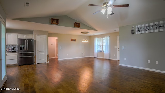 645 Bryce View Ln, Sevierville, TN 37876 - unfurnished living room featuring ceiling fan with notable chandelier, baseboards, vaulted ceiling, visible vents, and dark wood-style floors