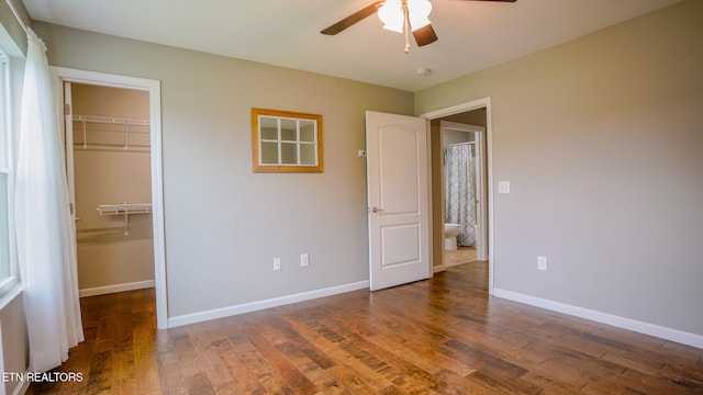 645 Bryce View Ln, Sevierville, TN 37876 - unfurnished bedroom with a walk in closet, baseboards, a closet, and wood finished floors
