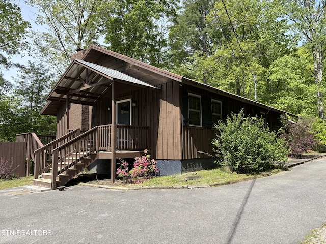 3461 Lost Branch Rd, Sevierville, TN 37862 - rustic home featuring board and batten siding and a chimney