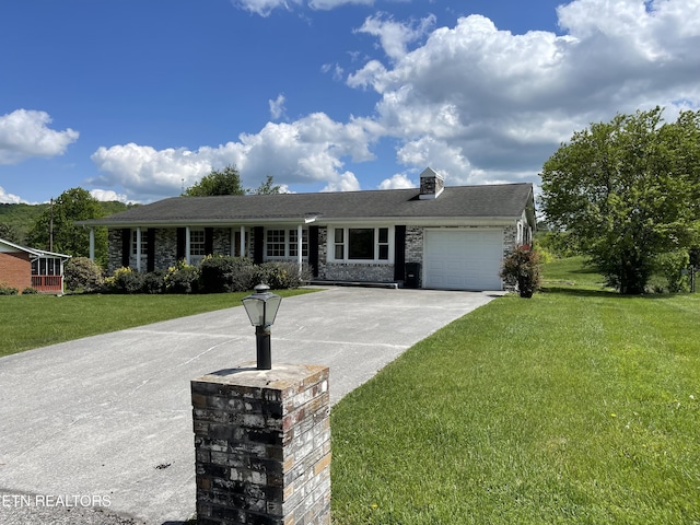 ranch-style house featuring concrete driveway, a garage, and a front yard