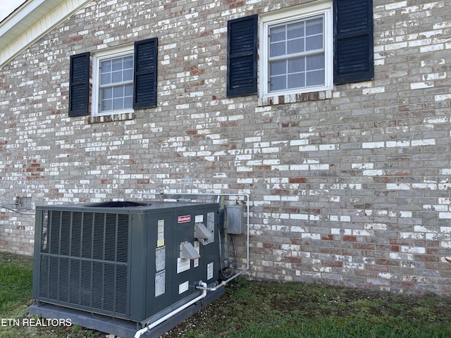 details with central air condition unit and brick siding