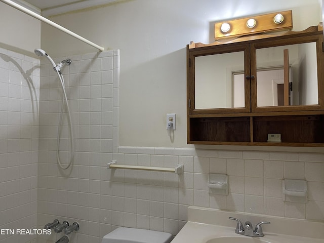 full bath with a sink, toilet, and washtub / shower combination