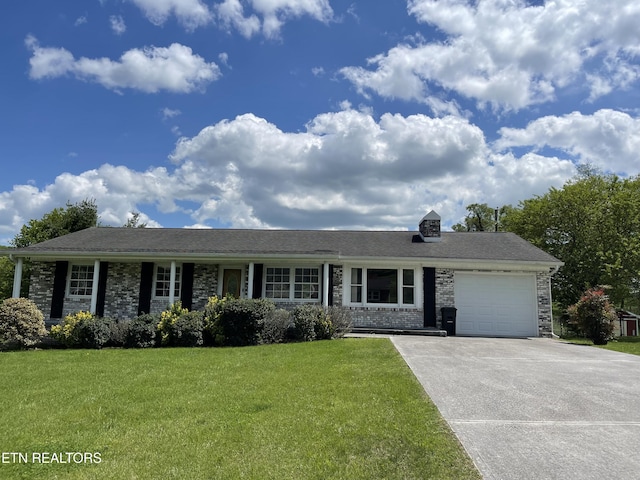 view of front facade with an attached garage, concrete driveway, and a front lawn