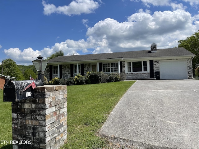 ranch-style home featuring a front lawn, a garage, and aphalt driveway