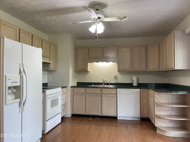 kitchen featuring a sink, white appliances, wood finished floors, open shelves, and dark countertops