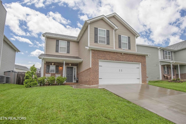 traditional-style home with a porch, brick siding, concrete driveway, and a front lawn
