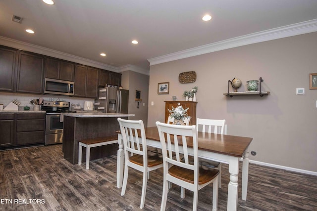 dining room featuring ornamental molding, dark wood-style flooring, recessed lighting, and baseboards