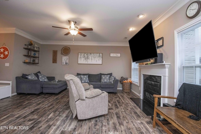 living area with ceiling fan, dark wood-style flooring, crown molding, a fireplace with flush hearth, and baseboards