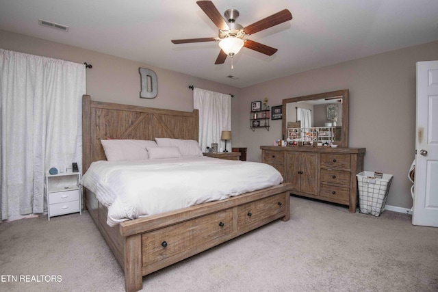 bedroom featuring light carpet and ceiling fan