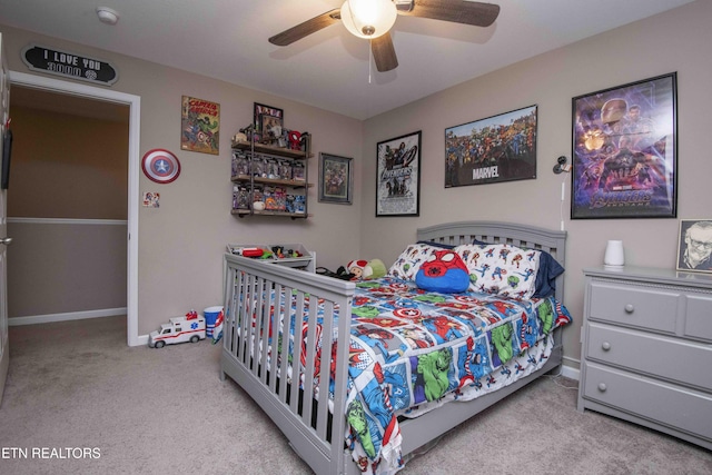 carpeted bedroom featuring baseboards and ceiling fan