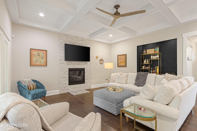 living area featuring coffered ceiling, beam ceiling, and wood finished floors