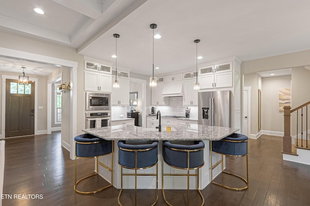kitchen featuring appliances with stainless steel finishes, dark wood-style flooring, custom exhaust hood, and white cabinets