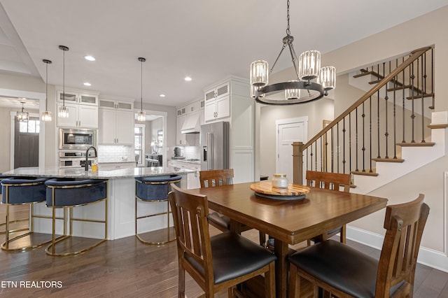 dining room featuring stairway, baseboards, recessed lighting, dark wood finished floors, and a notable chandelier